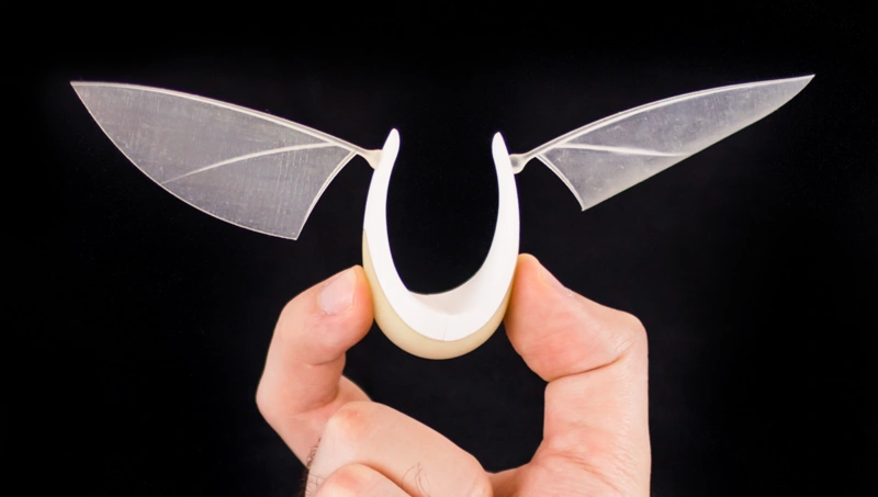 A hand holding the 1:1 scale 3D printed mockup of a Flyht lamp.